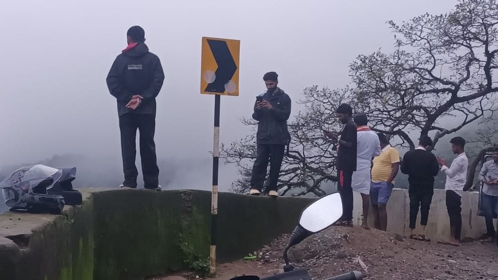 <div class="paragraphs"><p>Tourists standing on the reclining walls of Charmadi ghat on Sunday.</p></div>